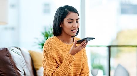 A woman recording a voice memo on her phone